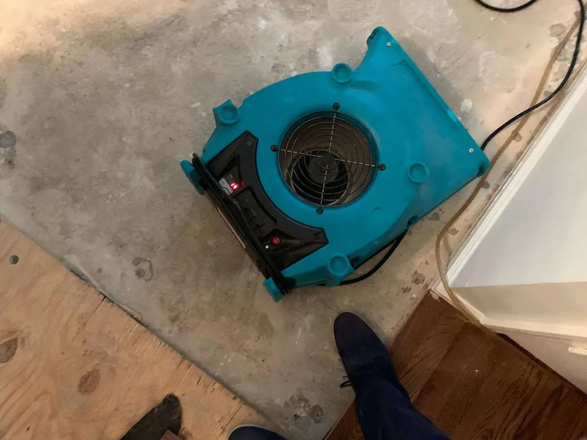 Air mover drying subfloor during Commercial Water Damage Restoration in Fairfield